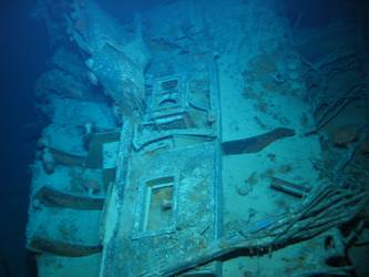 Unidentified wreckage on seabed, skylights visible. Jumble of wire.